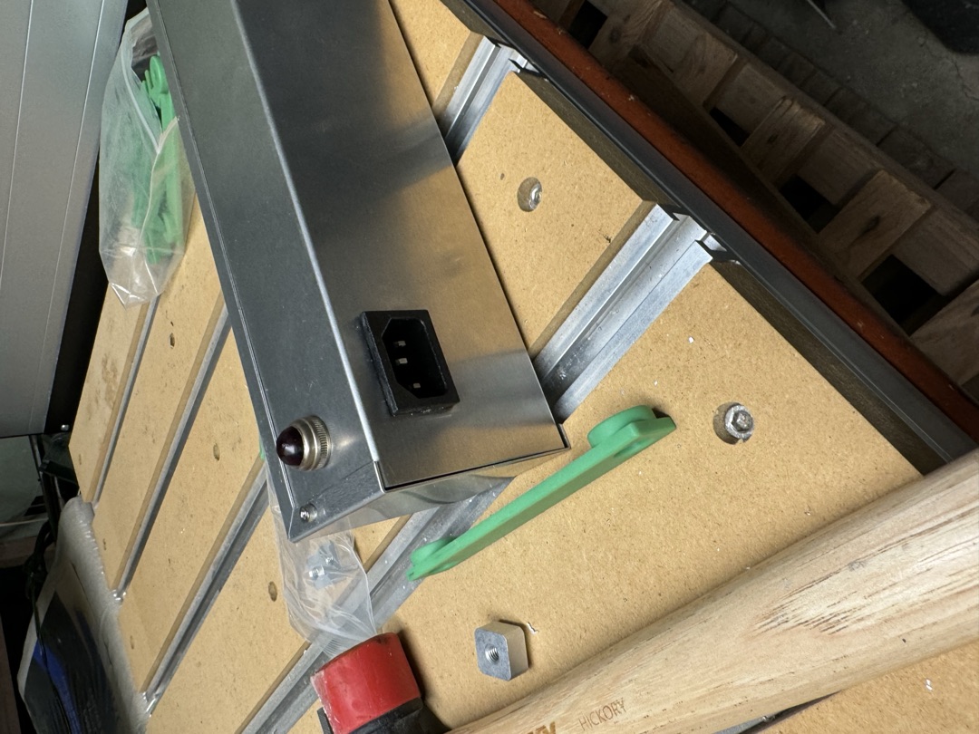 The bare chassis on the bench, its power inlet fitted