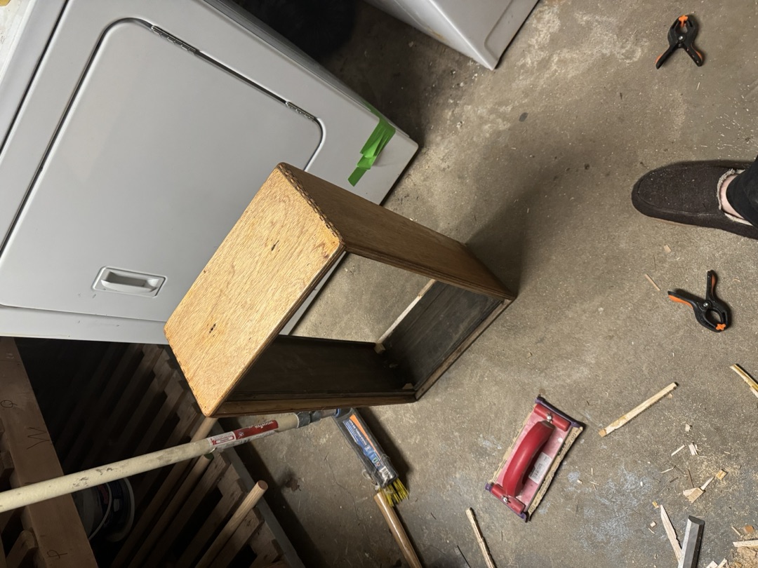 The cabinet carcass standing open in the workshop