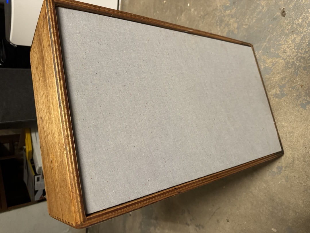 The cabinet with its grille cloth fitted and the wood finished
