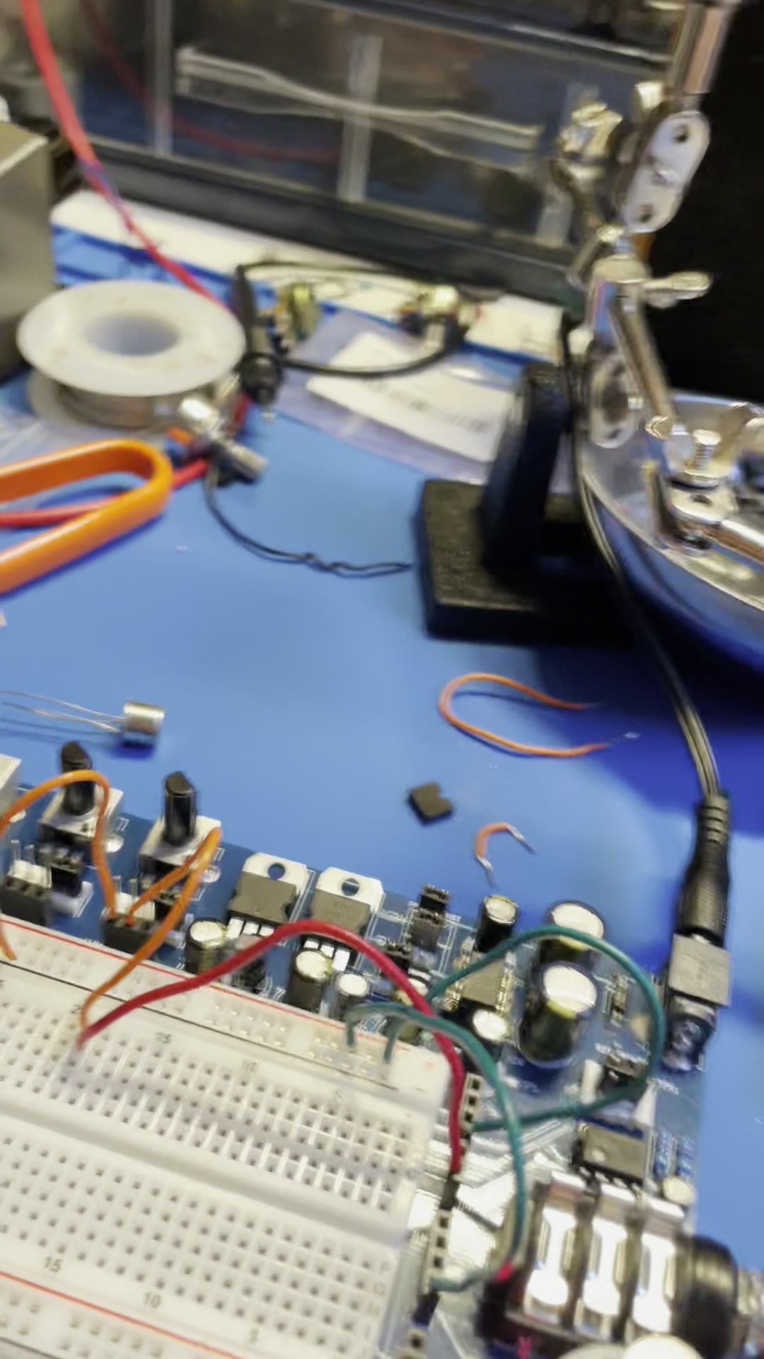 Stage Kiss pcb on the bench beside a soldering station