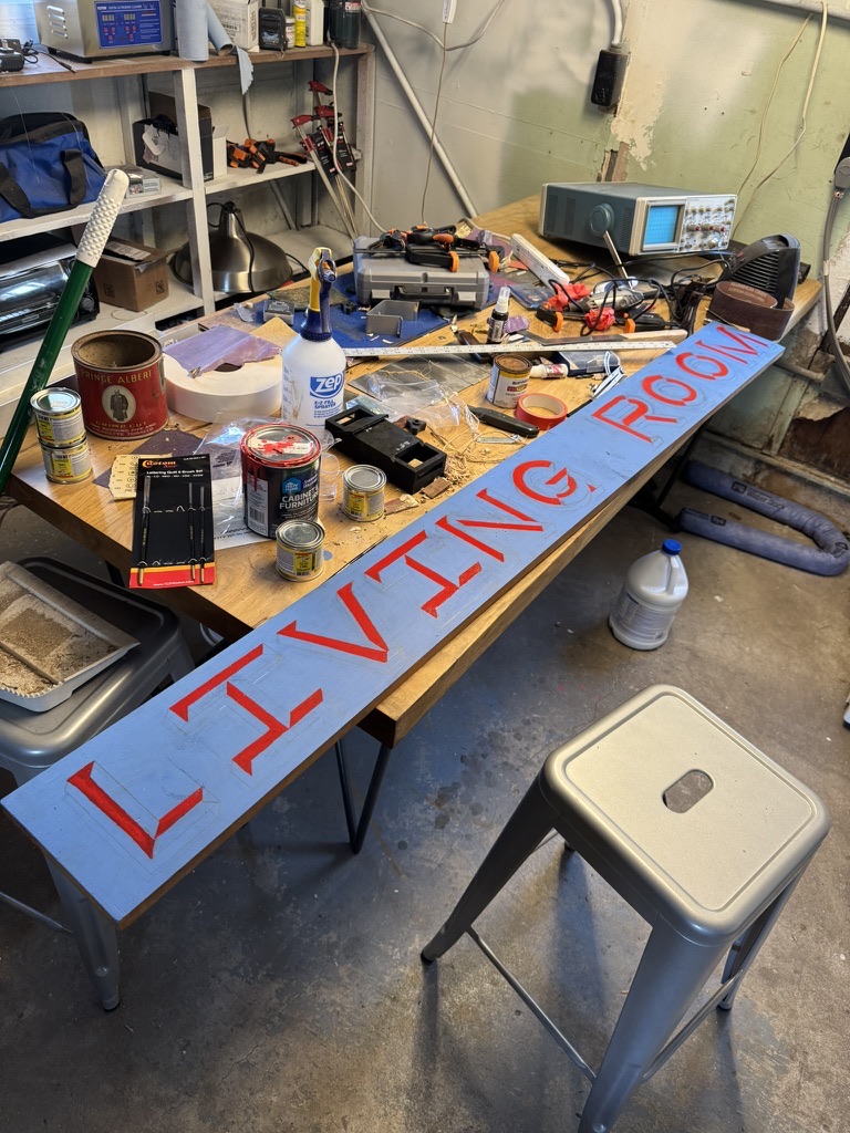 The letter faces filled in red, spelling LIVING ROOM across the board