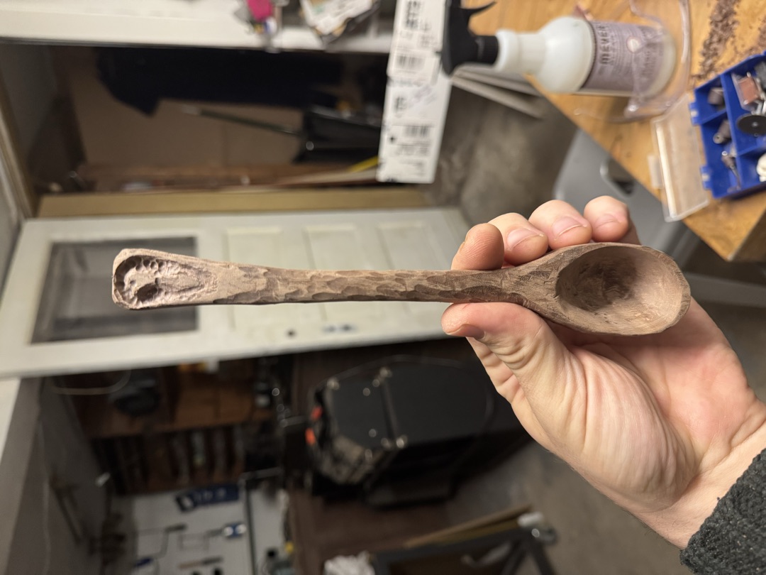The bowl hollowed out and the handle carved with a faceted texture