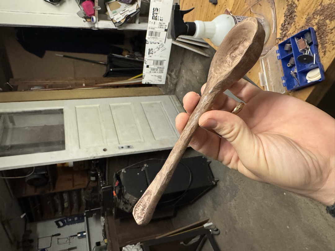 The spoon from the back, showing the curve of the bowl