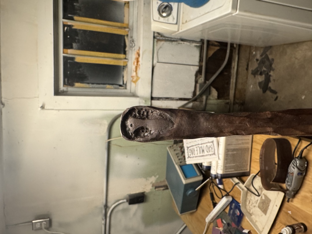 The spoon stood on end, looking down into the tool-marked bowl